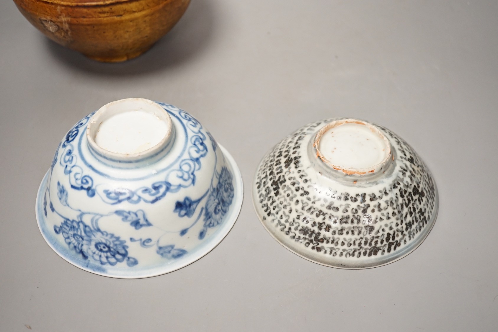 Two Chinese Ming blue and white bowls and a straw glazed jar of Martaban type - tallest 13cm